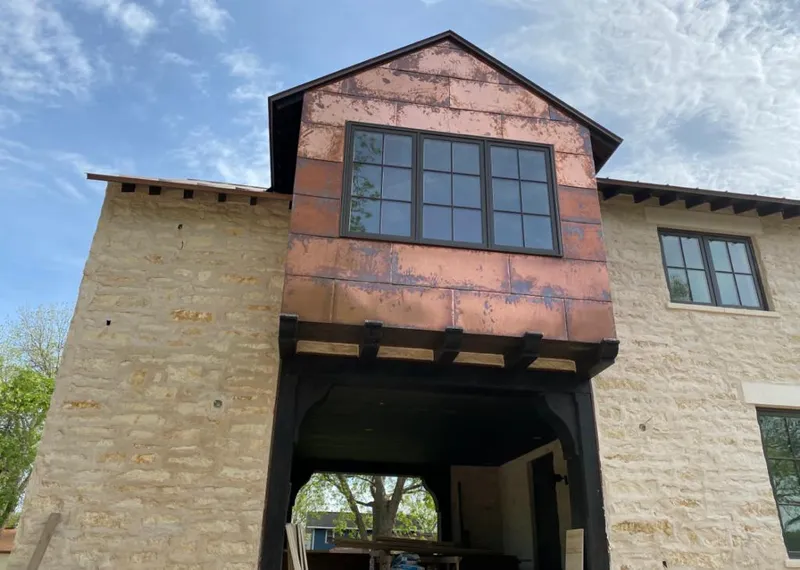 Copper metal panel facade on a stone building for Metal Roof Coating in Ada